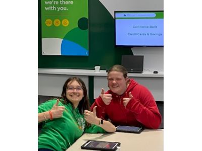 Students giving the thumbs up sign